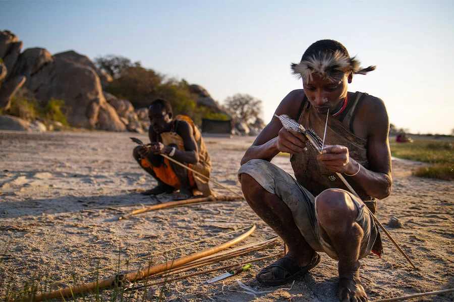 Hadzabe man beside a campfire