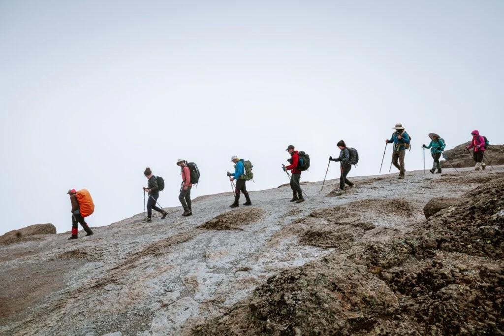Line of climbers crossing a rocky mountain slope