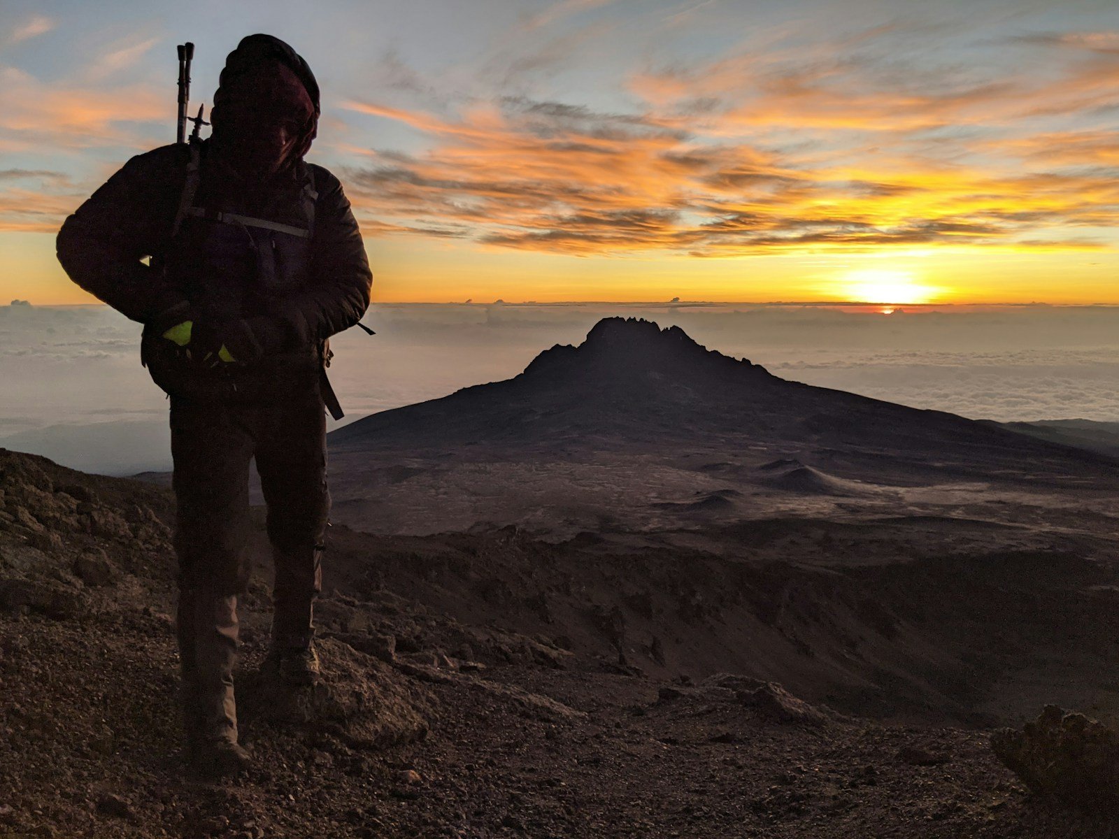 Hiker above the clouds at sunrise on Kilimanjaro — Tartaruga Safaris