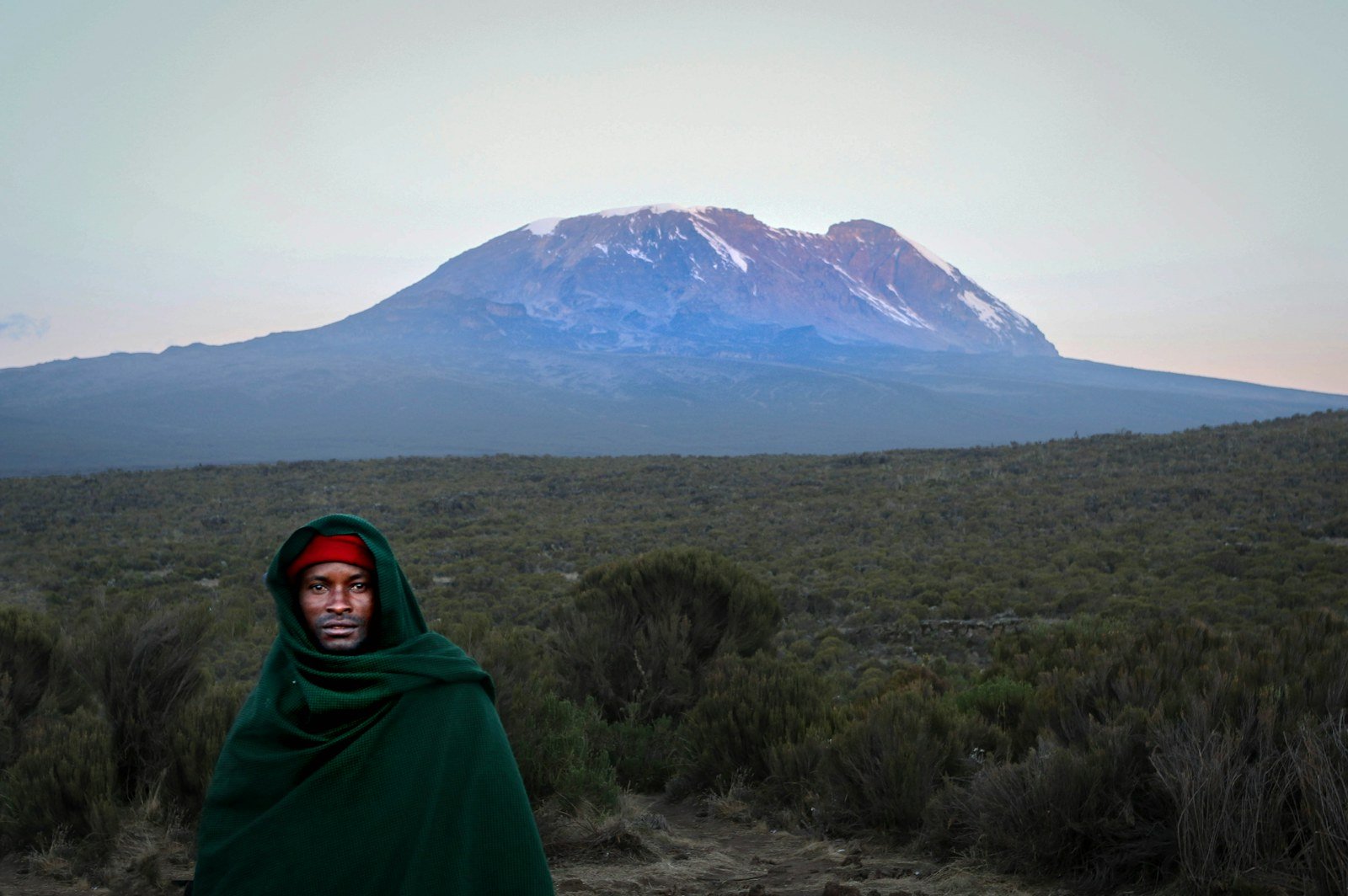 Kilimanjaro above green foothills — Northern Circuit climbing illustration