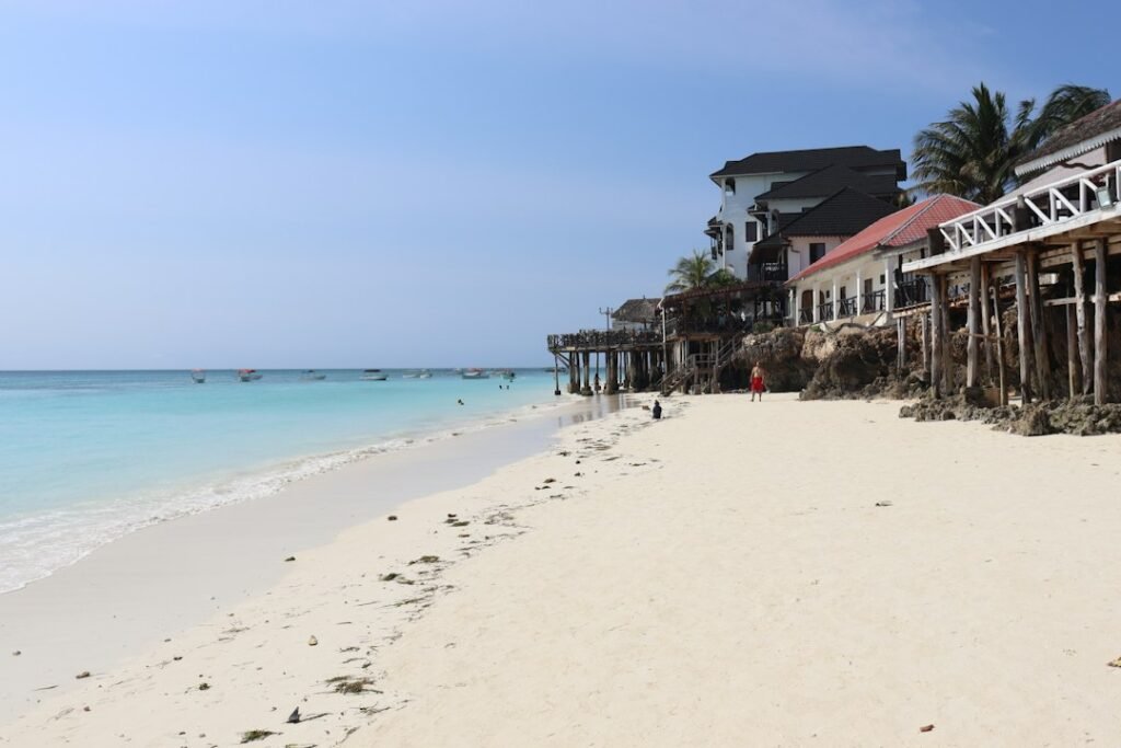 White sandy beach and coastal houses — Tanzania beach and island holidays
