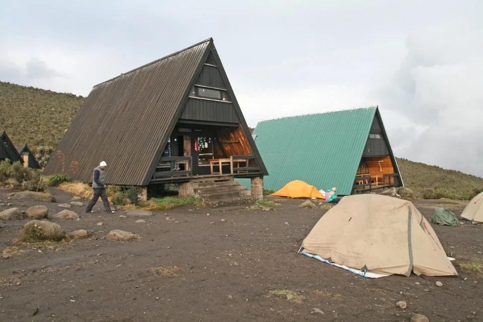 Mountain huts and tents on rocky ground