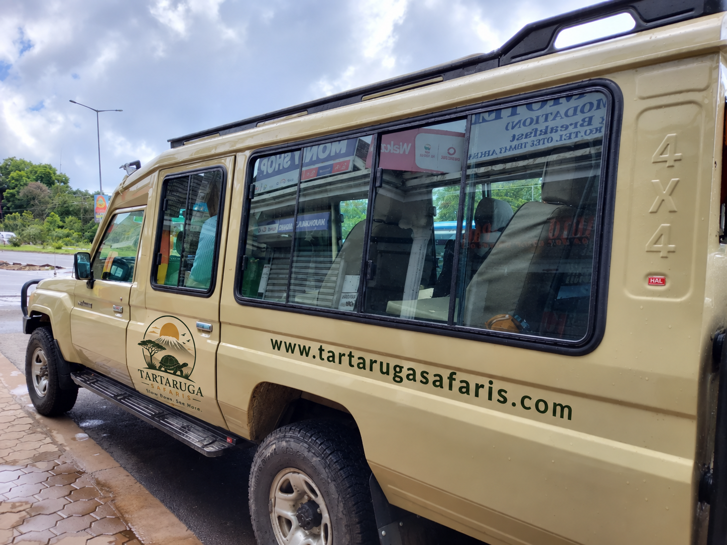 Safari vehicle with Tartaruga Safaris logo and website on its side