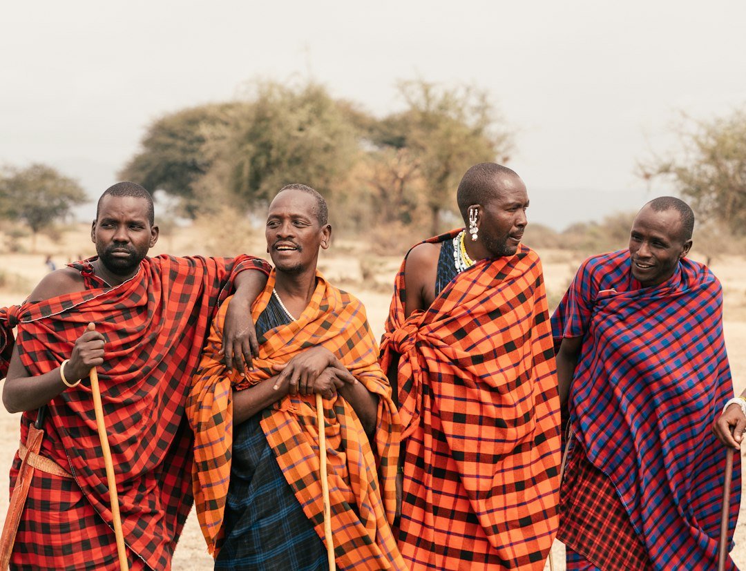 People wearing red and black traditional dress — Maasai overnight experience illustration