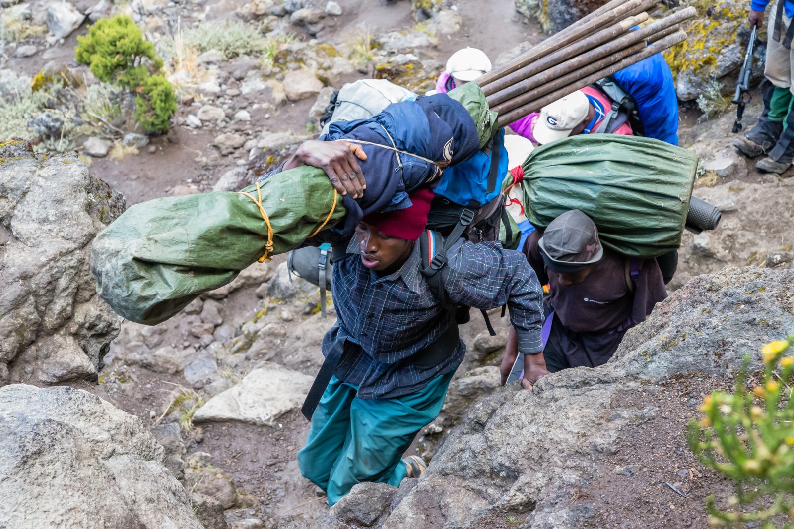 Porter carrying equipment before the Barranco Wall ascent in 2015